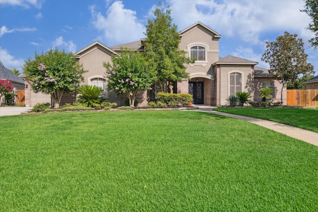 14002 Winding Springs Dr, Cypress, TX 77429 - obstructed view of property featuring driveway, stucco siding, an attached garage, and brick siding