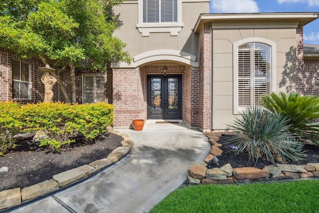 14002 Winding Springs Dr, Cypress, TX 77429 - doorway to property featuring french doors, brick siding, and stucco siding