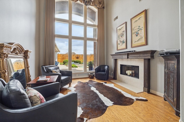 14002 Winding Springs Dr, Cypress, TX 77429 - living room with a fireplace, light wood-style floors, and a towering ceiling