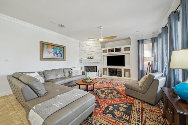 14002 Winding Springs Dr, Cypress, TX 77429 - living area with crown molding, a ceiling fan, light tile patterned floors, and a stone fireplace