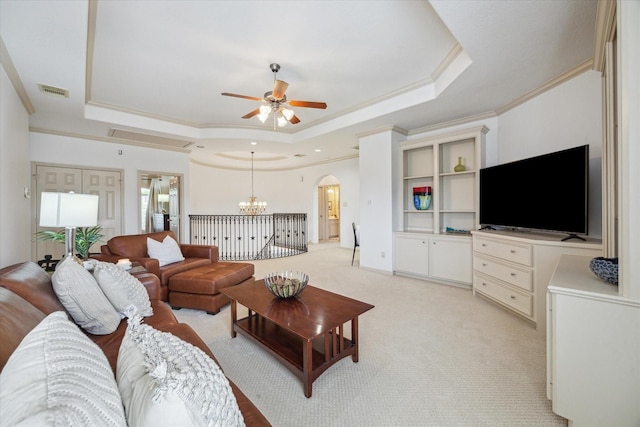 14002 Winding Springs Dr, Cypress, TX 77429 - living room featuring a raised ceiling, ornamental molding, a ceiling fan, arched walkways, and a chandelier