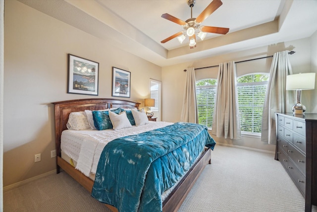 14002 Winding Springs Dr, Cypress, TX 77429 - bedroom featuring light carpet, a tray ceiling, and a ceiling fan