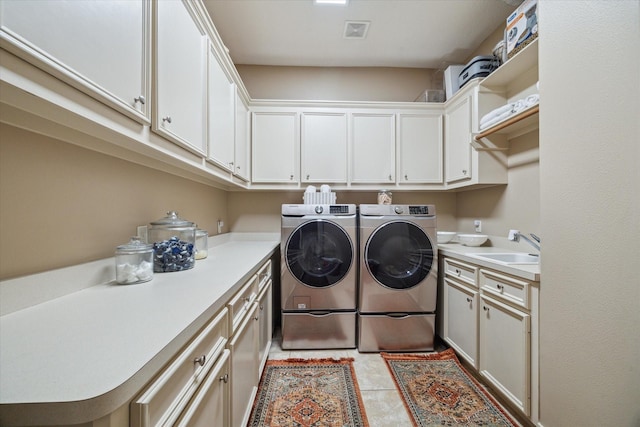 14002 Winding Springs Dr, Cypress, TX 77429 - laundry area with cabinet space, washer and dryer, and light tile patterned flooring
