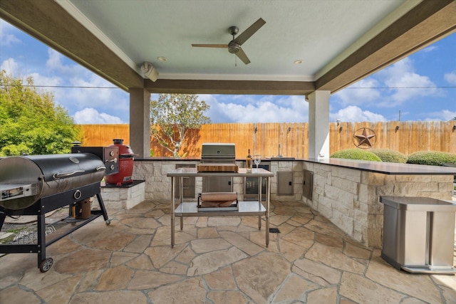 14002 Winding Springs Dr, Cypress, TX 77429 - fenced backyard featuring an outdoor kitchen, a patio area, and ceiling fan