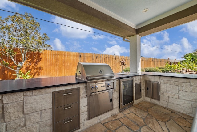 14002 Winding Springs Dr, Cypress, TX 77429 - fenced backyard with wine cooler, an outdoor kitchen, and a patio