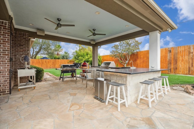 14002 Winding Springs Dr, Cypress, TX 77429 - fenced backyard with area for grilling, a patio area, and ceiling fan