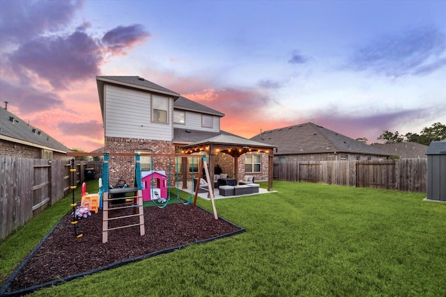 18827 Palmetto Hills Dr, New Caney, TX 77357 - back of house with a playground, brick siding, and a fenced backyard
