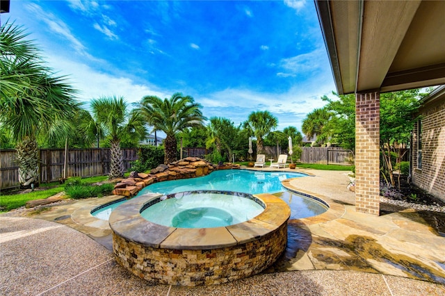 27818 Pinpoint Crossing Dr, Katy, TX 77494 - view of swimming pool with a patio, a fenced backyard, and a pool with connected hot tub
