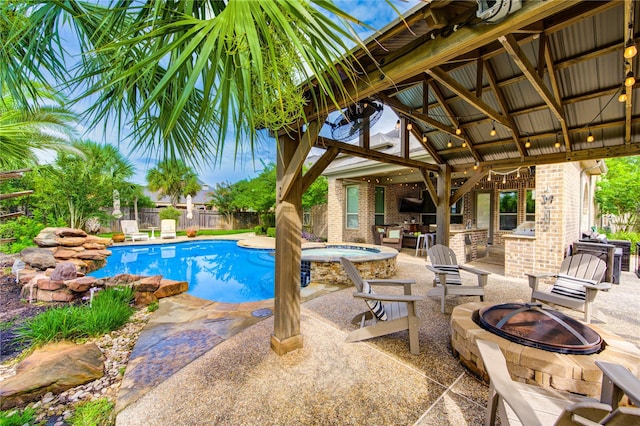 27818 Pinpoint Crossing Dr, Katy, TX 77494 - view of swimming pool with a fire pit, a gazebo, an outdoor kitchen, a fenced backyard, and a patio
