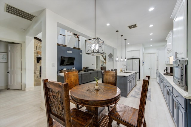 27818 Pinpoint Crossing Dr, Katy, TX 77494 - dining room featuring a chandelier, recessed lighting, and light wood-style floors