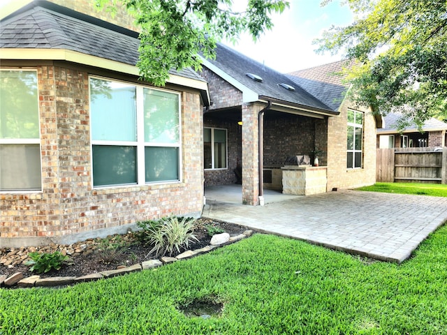 22106 Flashing Ridge Dr, Spring, TX 77389 - rear view of property with a patio area, roof with shingles, and brick siding