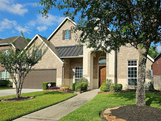 22106 Flashing Ridge Dr, Spring, TX 77389 - view of front of house with a front lawn, a standing seam roof, brick siding, and concrete driveway