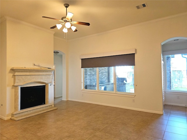 22106 Flashing Ridge Dr, Spring, TX 77389 - unfurnished living room with arched walkways, a ceiling fan, crown molding, a fireplace with raised hearth, and tile patterned flooring