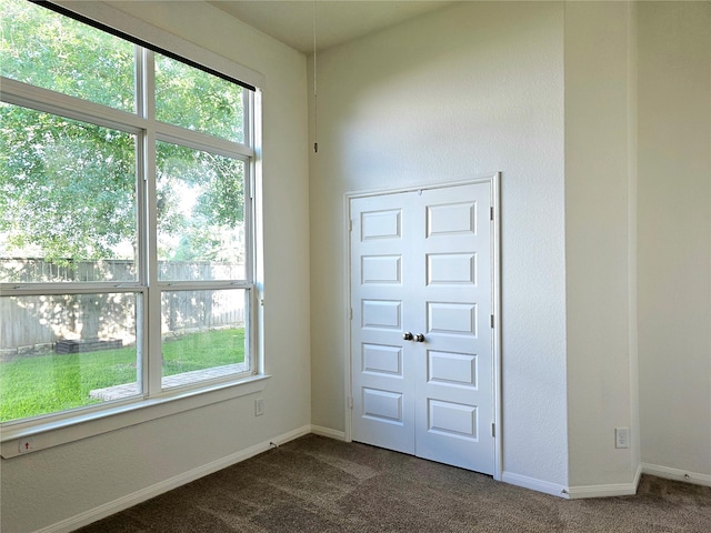 22106 Flashing Ridge Dr, Spring, TX 77389 - empty room with dark colored carpet and healthy amount of natural light