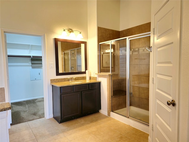 22106 Flashing Ridge Dr, Spring, TX 77389 - full bath featuring vanity, a shower stall, tile patterned floors, and a walk in closet