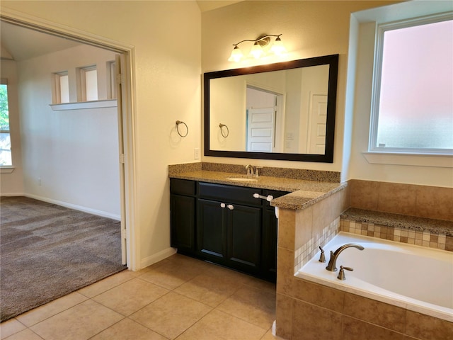 22106 Flashing Ridge Dr, Spring, TX 77389 - bathroom featuring vanity, a garden tub, and tile patterned floors