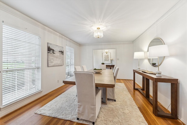 13307 Westport Ln, Houston, TX 77079 - dining room featuring wood finished floors, crown molding, and a chandelier