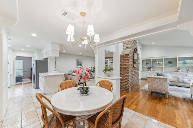 13307 Westport Ln, Houston, TX 77079 - dining area with light tile patterned floors, recessed lighting, and a chandelier
