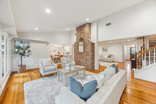 13307 Westport Ln, Houston, TX 77079 - living room featuring stairs, wood finished floors, high vaulted ceiling, and recessed lighting