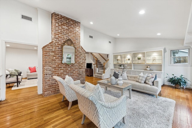 13307 Westport Ln, Houston, TX 77079 - living area with stairway, light wood finished floors, recessed lighting, and high vaulted ceiling