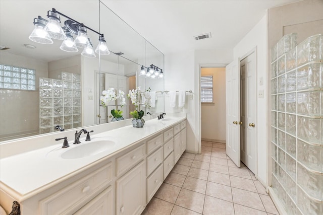 13307 Westport Ln, Houston, TX 77079 - bathroom featuring double vanity, tile patterned flooring, and walk in shower