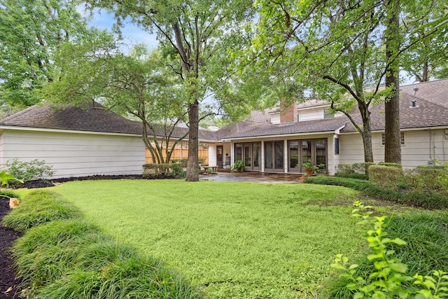 13307 Westport Ln, Houston, TX 77079 - back of house featuring a sunroom, a yard, a patio area, and a shingled roof
