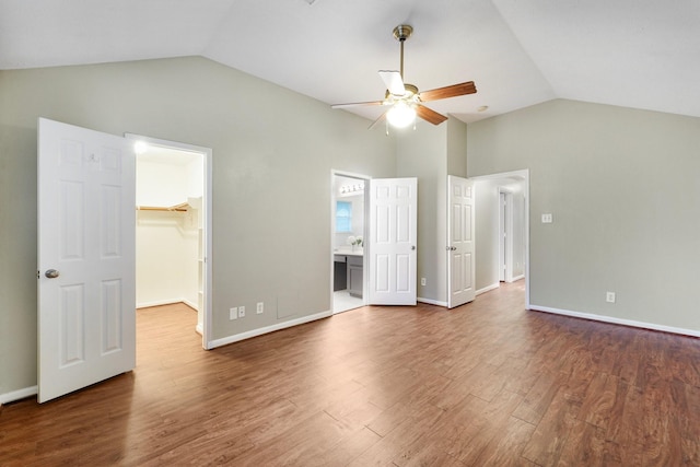 19115 Forest Ridge Dr, Magnolia, TX 77355 - unfurnished bedroom with vaulted ceiling, a spacious closet, wood finished floors, a closet, and ensuite bathroom