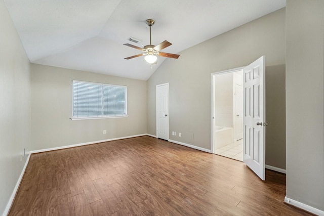 19115 Forest Ridge Dr, Magnolia, TX 77355 - unfurnished room featuring vaulted ceiling, wood finished floors, and ceiling fan