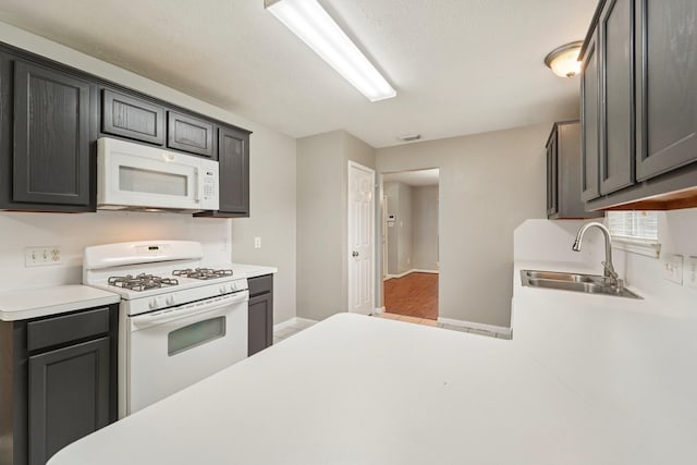 19115 Forest Ridge Dr, Magnolia, TX 77355 - kitchen with white appliances, light countertops, and a textured ceiling