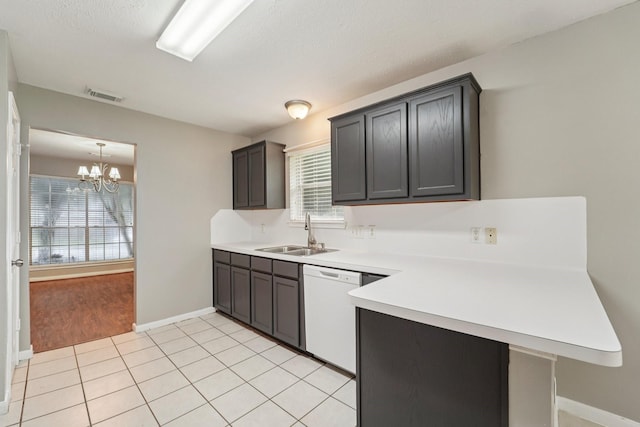 19115 Forest Ridge Dr, Magnolia, TX 77355 - kitchen with white dishwasher, a peninsula, healthy amount of natural light, and light countertops