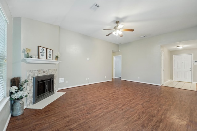 19115 Forest Ridge Dr, Magnolia, TX 77355 - unfurnished living room featuring ceiling fan, wood finished floors, and a fireplace with raised hearth