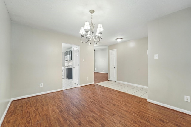 19115 Forest Ridge Dr, Magnolia, TX 77355 - spare room with light wood-type flooring and a chandelier