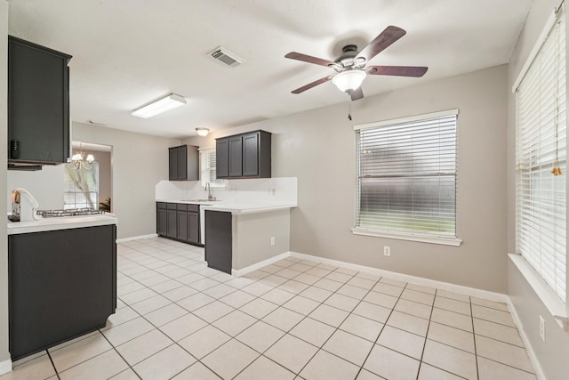 19115 Forest Ridge Dr, Magnolia, TX 77355 - kitchen with a peninsula, light countertops, ceiling fan, a chandelier, and healthy amount of natural light