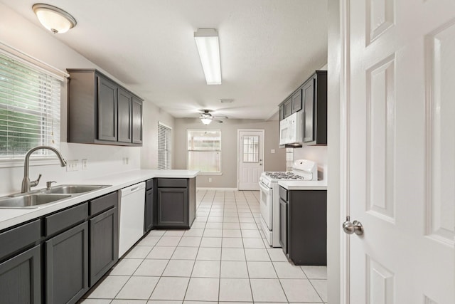 19115 Forest Ridge Dr, Magnolia, TX 77355 - kitchen featuring white appliances, a ceiling fan, light tile patterned floors, and light countertops