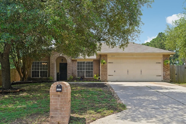 19115 Forest Ridge Dr, Magnolia, TX 77355 - view of front of house featuring brick siding, an attached garage, and driveway