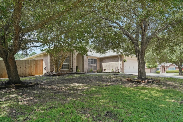 19115 Forest Ridge Dr, Magnolia, TX 77355 - obstructed view of property with brick siding, a garage, and driveway