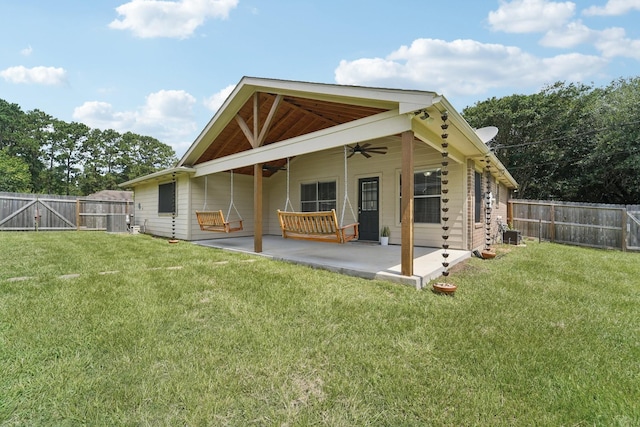 19115 Forest Ridge Dr, Magnolia, TX 77355 - back of house featuring ceiling fan, a fenced backyard, a patio, and a gate