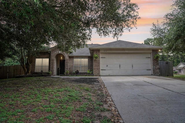19115 Forest Ridge Dr, Magnolia, TX 77355 - view of front of home with driveway, brick siding, and an attached garage