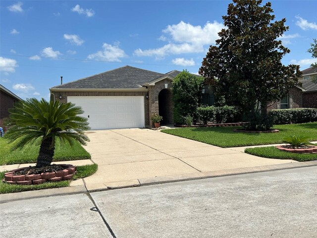 11618 Wren Crossing Dr, Houston, TX 77038 - view of front of home with brick siding, an attached garage, driveway, a front lawn, and roof with shingles