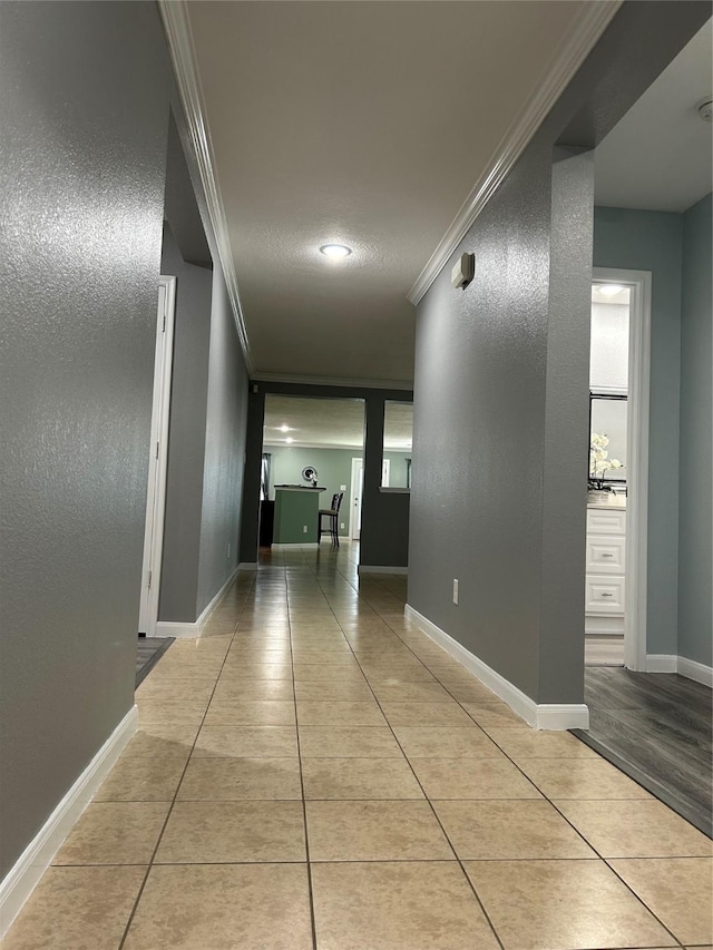 11618 Wren Crossing Dr, Houston, TX 77038 - hallway with ornamental molding and light tile patterned floors