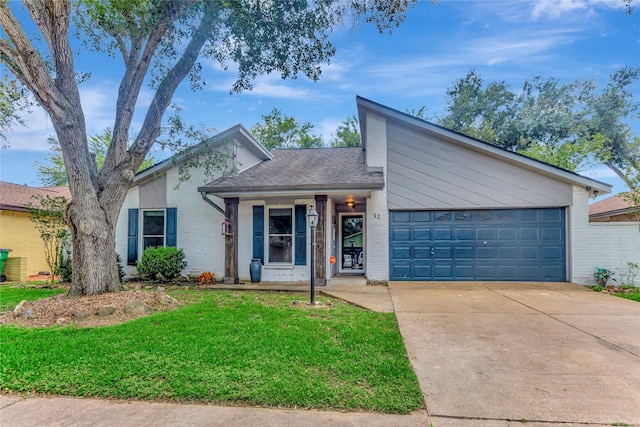 32 Sarita Rd, Angleton, TX 77515 - mid-century modern home featuring brick siding, driveway, a front yard, and an attached garage