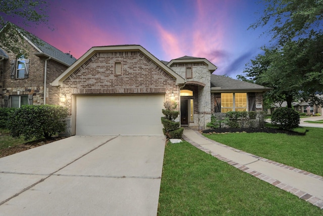 12131 Cove Ridge Ln, Cypress, TX 77433 - french country home with a garage, concrete driveway, a front lawn, brick siding, and stone siding