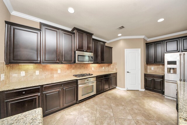 12131 Cove Ridge Ln, Cypress, TX 77433 - kitchen featuring appliances with stainless steel finishes, light stone counters, decorative backsplash, recessed lighting, and dark brown cabinets