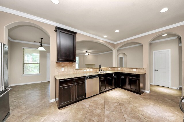 12131 Cove Ridge Ln, Cypress, TX 77433 - kitchen with stainless steel appliances, decorative backsplash, light stone countertops, ornamental molding, and a ceiling fan