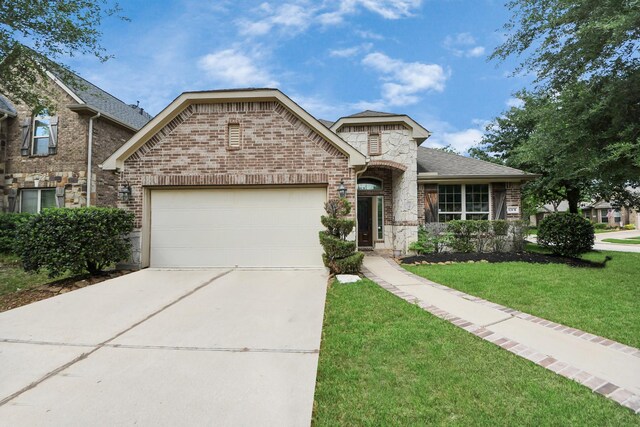 12131 Cove Ridge Ln, Cypress, TX 77433 - french provincial home featuring brick siding, an attached garage, driveway, a front yard, and roof with shingles