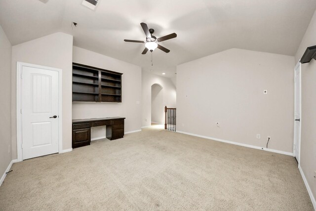 12131 Cove Ridge Ln, Cypress, TX 77433 - unfurnished living room with lofted ceiling, a ceiling fan, light colored carpet, built in study area, and arched walkways