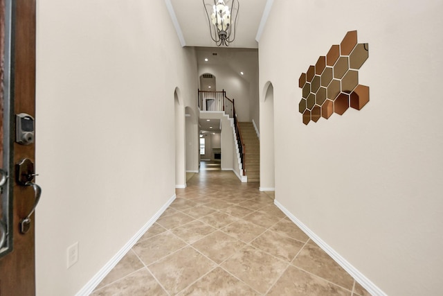 12131 Cove Ridge Ln, Cypress, TX 77433 - hallway with arched walkways, stairs, light tile patterned floors, and crown molding