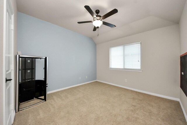 12131 Cove Ridge Ln, Cypress, TX 77433 - unfurnished bedroom with carpet, vaulted ceiling, and a ceiling fan