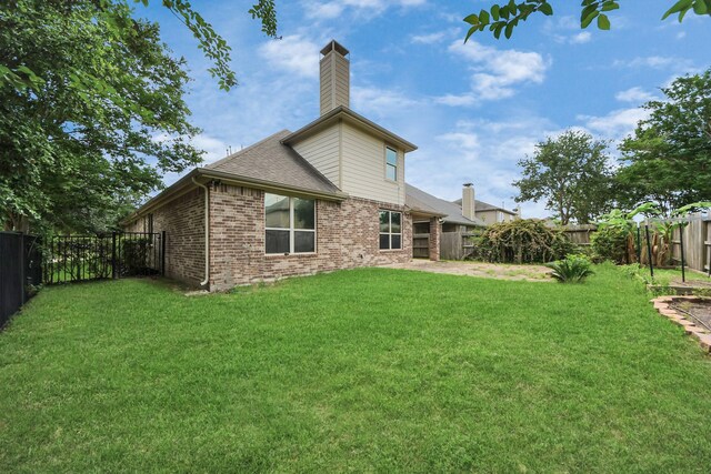 12131 Cove Ridge Ln, Cypress, TX 77433 - rear view of house featuring a fenced backyard, a chimney, brick siding, and a shingled roof