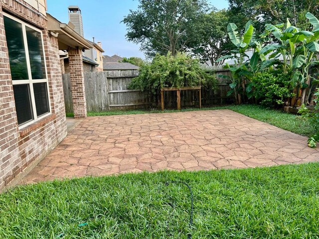 12131 Cove Ridge Ln, Cypress, TX 77433 - fenced backyard with a patio area